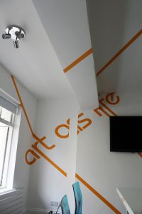 anamorphic graphics with writing on the wall