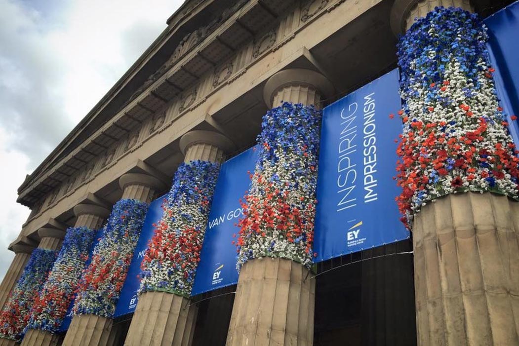 inspiring impressionism message on stone pillars with flowers arranged along them