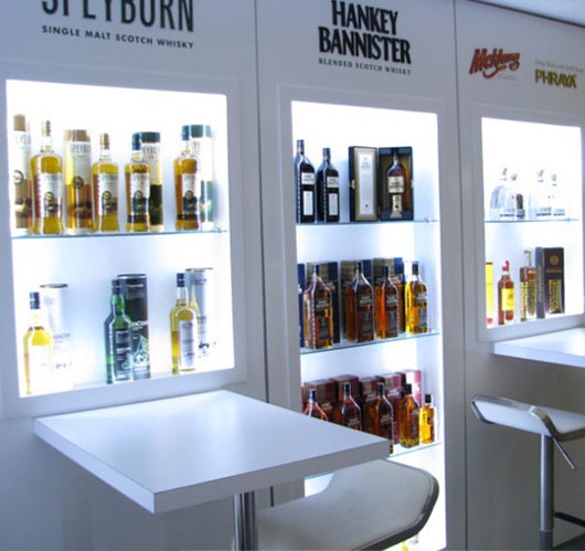 International Beverage exhibition stand with whisky bottles on the wall