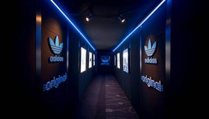 dark hallways with adidas original signs on the wall in neon blue