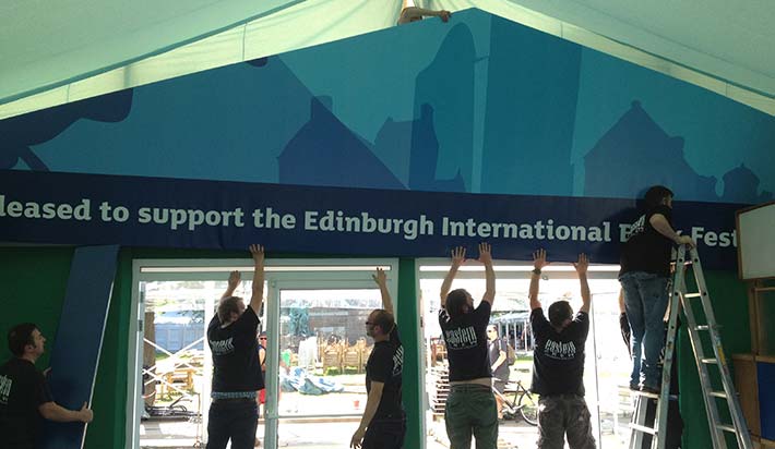 putting up the edinburgh book festival sign