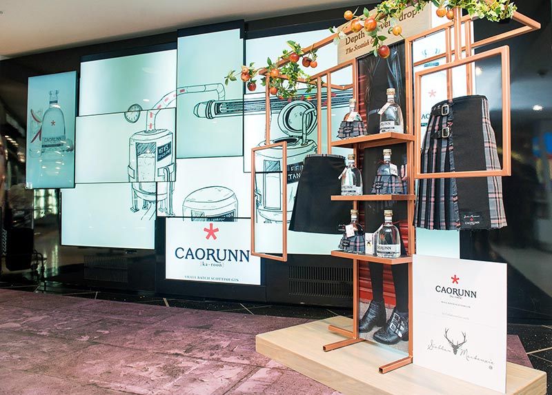 caorunn gin bottles, kilts and glass graphics