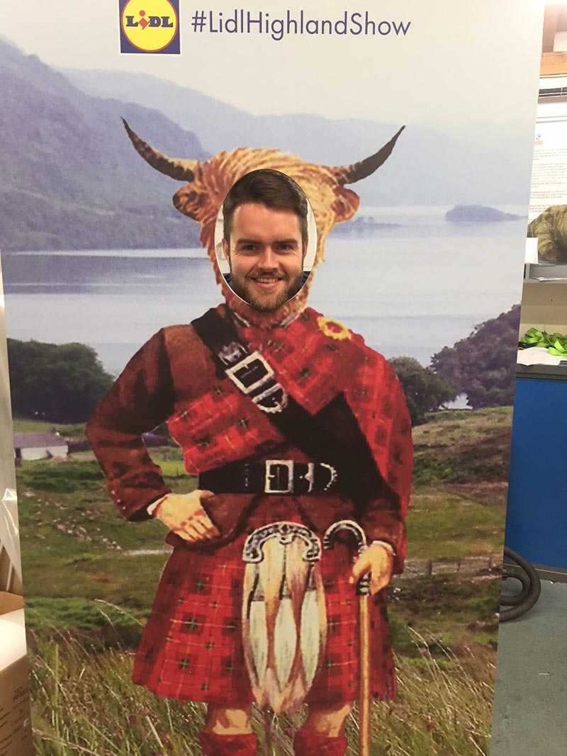 prop with highland dress and highland cow head with a cut out so a man can show his face through it