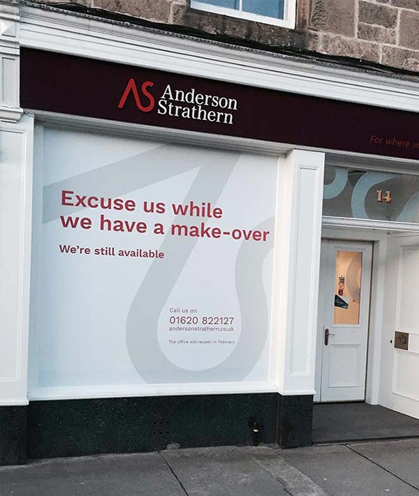 having a make over message shopfront hoarding