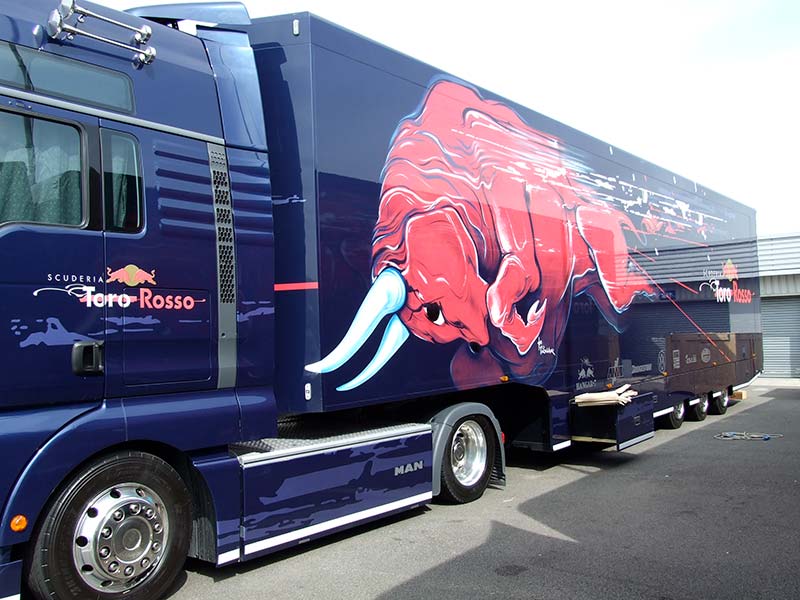 toro rosso truck from the side showing of the new red bull 