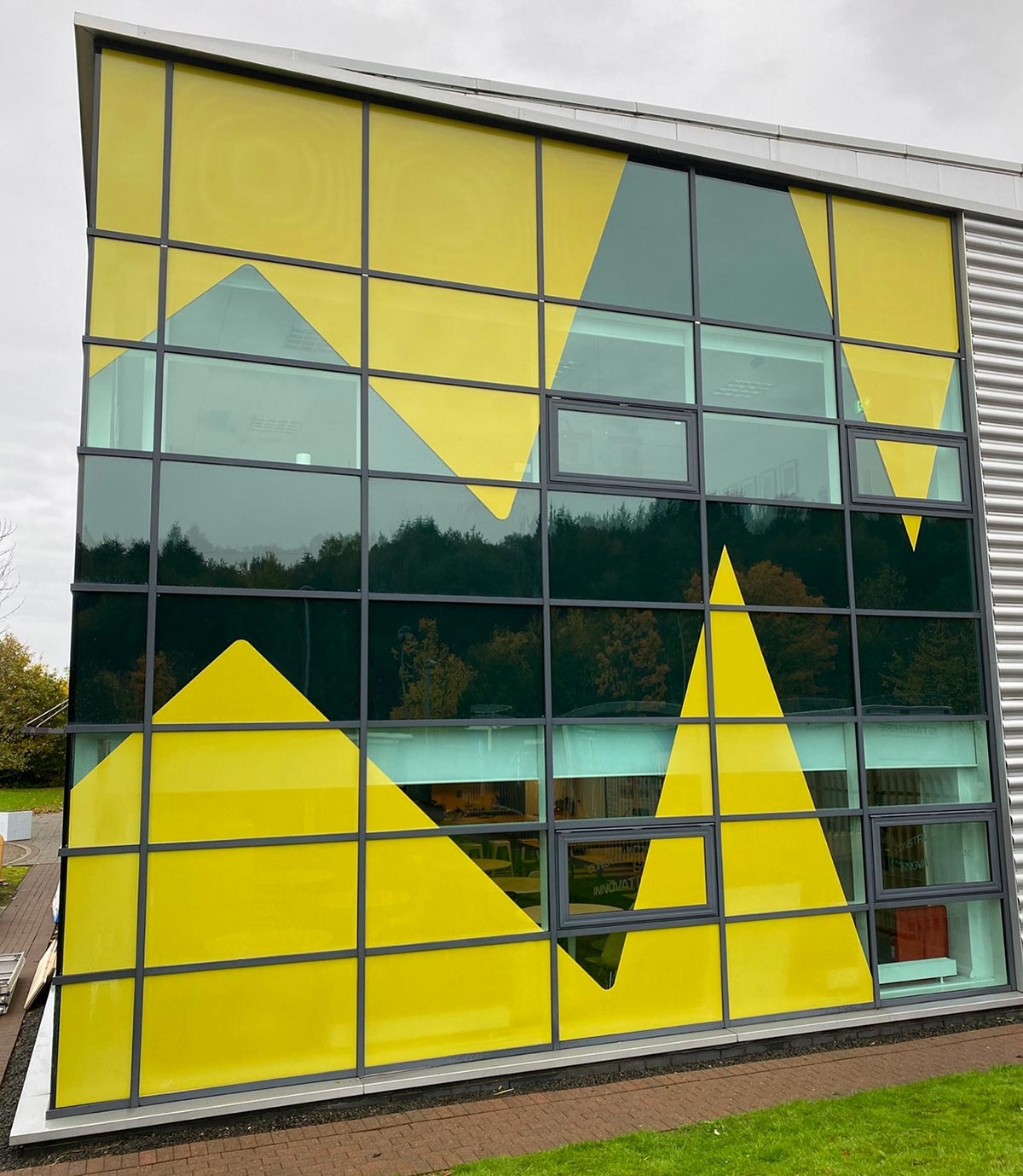 yellow graphics on the office window at cop26