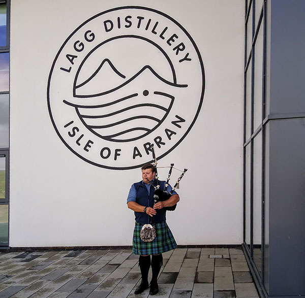 piper with lagg distillery sign in the background